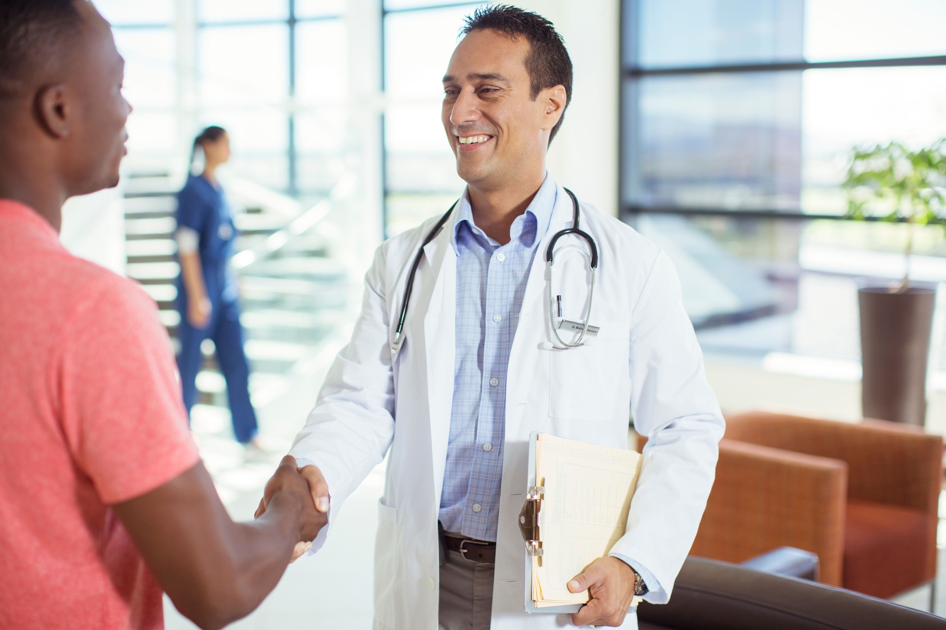Doctor and patient shaking hands in hospital